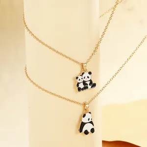 Detail view of two panda-shaped oil drip necklaces with golden alloy chains