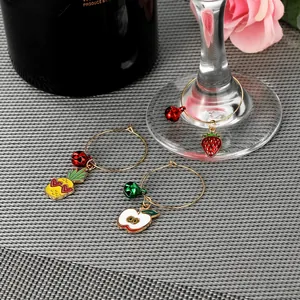 Detail of fruit charms and bells on gold rings for wine glass decoration