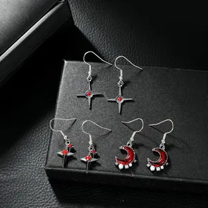 Detailed close-up of retro silver earrings with red gemstones on black jewelry box