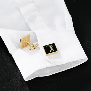 Detail of square gold and black enamel cufflinks featuring a golfer silhouette on a white shirt