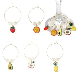 Five fruit-shaped wine glass charms set with strawberry and pineapple pendants