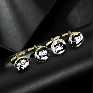 Macro detail of round gold cufflinks with black and white cat illustration art