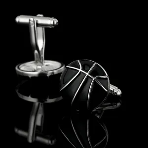 Polished metal basketball cufflinks with black enamel texture on a reflective black background