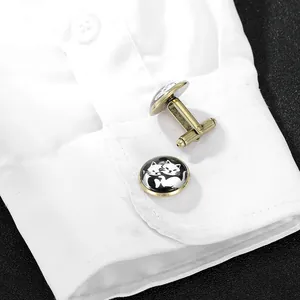 Vintage bronze round cufflinks with cat motif displayed on a white shirt cuff