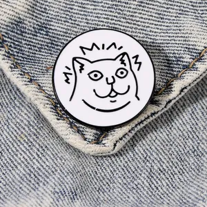 Cute cartoon cat enamel pin with MIAU text on blue denim fabric background