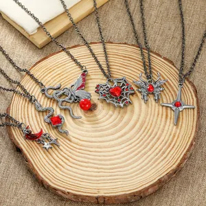 Detailed close-up of Gothic necklace set with snake, butterfly, and heart charms