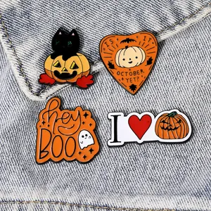 Set of four cute Halloween metal enamel pins featuring pumpkin and ghost on denim fabric