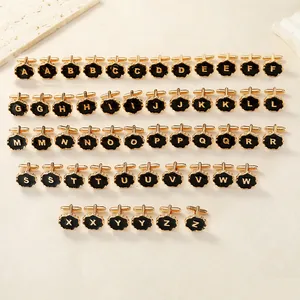 Collection of gold mens cufflinks featuring black enamel wave edges and A-Z initial letters