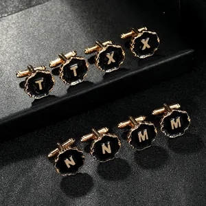 Classic round gold plated cufflink with black enamel and raised letter detail