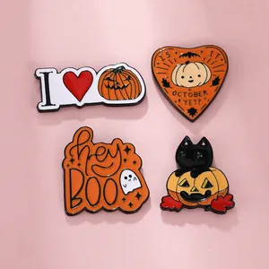 Detail of four colorful Halloween enamel pins with ghost, pumpkin, and black cat designs