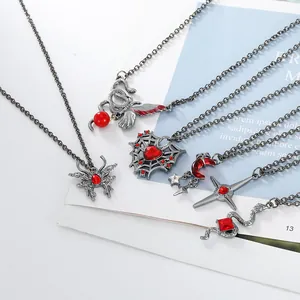 Close-up of gothic necklace set featuring snake, bat, and spider pendants in vintage silver
