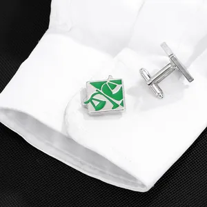 Exquisite silver round cufflinks with green enamel justice scale on a white shirt cuff