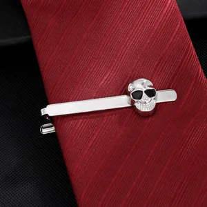 Pince à cravate tête de mort en argent poli pour homme sur une cravate rayée rouge foncé