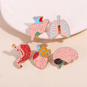 Detailed close-up of colorful organ enamel pins including heart, brain and lungs