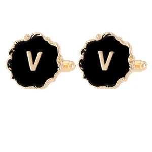 Elegant gold and black enamel cufflinks with a textured V initial for formal shirts