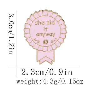 Pink enamel ribbon medal brooch with she did it anyway text and detailed size markers