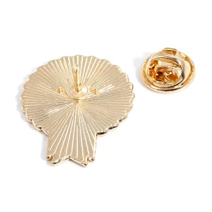 Golden metal medal badge back view with butterfly clutch and textured finish