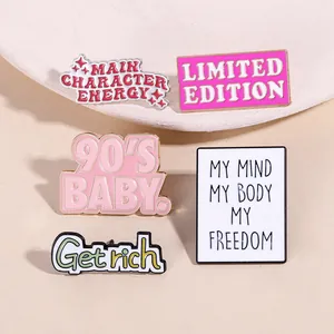 Detailed close-up of 5 colorful enamel letter pins with golden edges on a white display