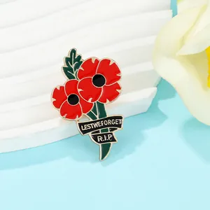 Detailed macro of a red poppy enamel brooch with Lest We Forget and R.I.P inscription