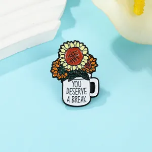 Detail of flower enamel pin featuring sunflower bouquet in mug with quote text