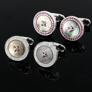 Close-up of luxury round button cufflinks with iridescent mother of pearl and pavé crystals