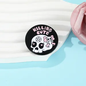 Détail d'un pin's en émail tête de mort goth-cute sur un support ondulé avec texte rose