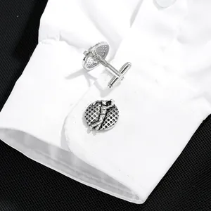 Polished silver golf cufflinks with golfer swing design on white french dress shirt cuff