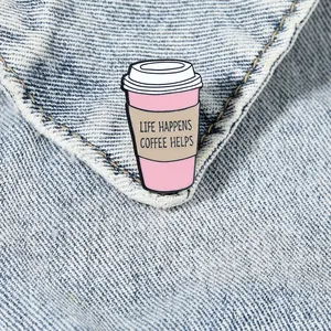 Enamel coffee cup brooch with Life Happens Coffee Helps quote on denim background