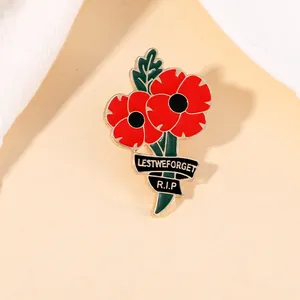 Detailed view of red poppy brooch with Lest We Forget text and rhinestones on alloy