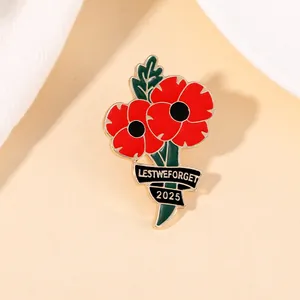Detail of red poppy flower enamel brooch with Lest We Forget 2025 ribbon inscription