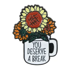 Enamel sunflower pin in mug with You Deserve A Break text on white background