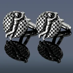 Silver golf cufflinks showing a golfer swing relief with textured ball pattern background