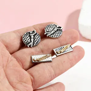 Macro detail of luxury golf themed cufflinks featuring swing golfer and clubs