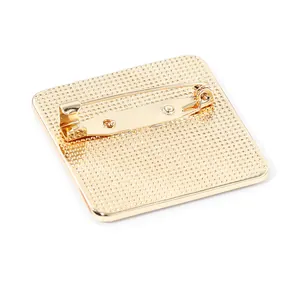 Back view of square gold alloy city brooch showing textured finish and safety pin clasp