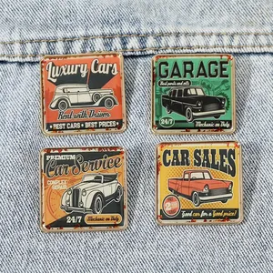 Close-up of a 4-piece set of vintage square car enamel pins on blue denim fabric