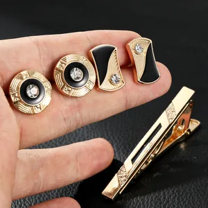 Men's gold cufflinks and tie clip set with black enamel and white crystal accents