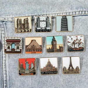 Set of 10 vintage enamel city landmark brooches with world building icons on denim