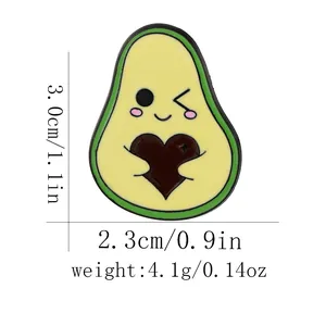 Cute cartoon avocado enamel pin with a brown heart including product size measurements