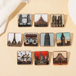 Detailed set of 10 square enamel pins featuring iconic world landmarks on a beige backdrop