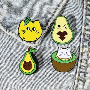Cartoon metal enamel pins featuring cute black cats merged with fruit shapes on denim