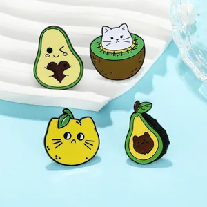 Close-up of colorful enamel cat and fruit pins showing detailed metal craftsmanship