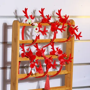 Red Christmas reindeer antler headbands with plush balls and floral lace details