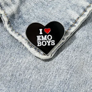 Heart-shaped I Love Emo Boys enamel pin on blue denim jacket for punk fashion style