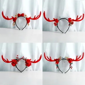Close-up of four Christmas reindeer headbands featuring festive berries, bows, and pine needles