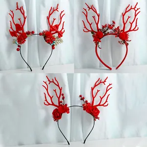 Detailed view of three festive red Christmas reindeer antler headbands with floral accents