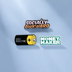Detailed close-up of three enamel pins with Socially Awkward and Stay Positive slogans