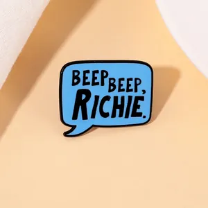 Detail of blue speech bubble enamel pin with BEEP BEEP, RICHIE. movie quote text