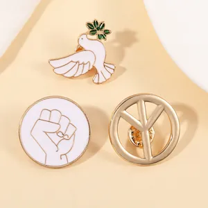 Detail view of peace dove enamel pins set including olive branch and unity symbols