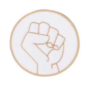 Minimalist round metal dove peace brooch with golden clenched fist and white enamel