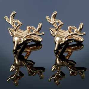 Detailed macro view of golden stag head cufflinks with mirror reflection on blue surface